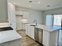 Modern kitchen featuring white cabinets, quartz countertops, and stainless steel appliances at 15371 W Desert Hollow Dr, Surprise, AZ 85387