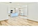 Open living room with wood-look flooring and views into the kitchen at 15371 W Desert Hollow Dr, Surprise, AZ 85387