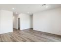 Bright and spacious living room with wood-look flooring at 15429 W Hackamore Dr, Surprise, AZ 85387