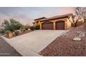 Home exterior showcasing a long driveway leading to a three-car garage at 15639 E Palomino Blvd, Fountain Hills, AZ 85268