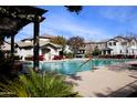 Community pool and lounge area with pergola in a beautiful planned community at 16405 W Latham St, Goodyear, AZ 85338