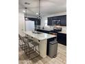 Modern kitchen with granite countertops, subway tile backsplash, and stainless steel appliances at 16405 W Latham St, Goodyear, AZ 85338