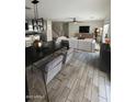Spacious living room with hardwood floors, modern furnishings, and an open floor plan at 16405 W Latham St, Goodyear, AZ 85338