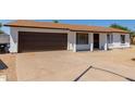 Charming single-story home with a brown garage door at 17052 N 36Th Ct, Phoenix, AZ 85032