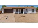 Charming single-story home with a brown garage door at 17052 N 36Th Ct, Phoenix, AZ 85032