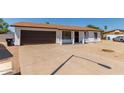 Charming single-story home with a brown garage door at 17052 N 36Th Ct, Phoenix, AZ 85032