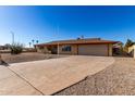 Single story home with a two-car garage and spacious driveway at 1741 N Lehmberg Ave, Casa Grande, AZ 85122