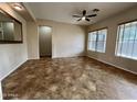 Living area with tile flooring and a ceiling fan at 17597 W Aster Dr, Surprise, AZ 85388