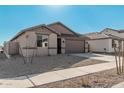 Single-story house with neutral color scheme and a two-car garage at 18411 W Monte Lindo Ln, Surprise, AZ 85387