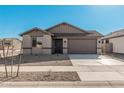 Single-story house with a two-car garage, neutral exterior, and small front yard at 18411 W Monte Lindo Ln, Surprise, AZ 85387