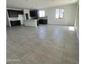 Open living area with spacious layout and neutral-toned tile flooring at 18411 W Monte Lindo Ln, Surprise, AZ 85387