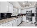 Bright kitchen with granite countertops and stainless steel appliances at 19098 N 97Th Ln, Peoria, AZ 85382