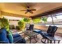 Covered patio with comfortable seating area, perfect for relaxing outdoors at 19098 N 97Th Ln, Peoria, AZ 85382