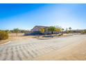 Property view showcasing a single-story home and surrounding desert landscape at 19350 W Clarendon Ave, Litchfield Park, AZ 85340