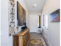 Bright entryway with decorative wall art and a wooden console table at 19350 W Clarendon Ave, Litchfield Park, AZ 85340