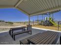 Covered picnic area with tables and benches near playground at 24151 W Hidalgo Ave, Buckeye, AZ 85326