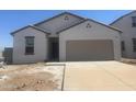 Newly built home with a two-car garage and unfinished landscaping at 24151 W Hidalgo Ave, Buckeye, AZ 85326