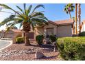 Tan home with desert landscaping, a large palm tree, and a walkway at 25046 S Foxglenn Dr, Sun Lakes, AZ 85248