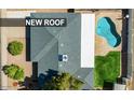 Aerial view of a home showcasing a new roof, pool, grassy area, and patio at 2818 S Cottonwood Dr, Tempe, AZ 85282