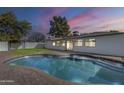 Inviting kidney-shaped pool with brick patio and backyard at 2818 S Cottonwood Dr, Tempe, AZ 85282