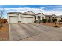 Two-car garage, driveway, and nicely landscaped front yard at 3224 N Lainey Ln, Buckeye, AZ 85396