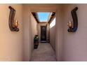 Light and airy entryway with tiled floors and wall-mounted lights at 36038 N Puente Alto Ave, Queen Creek, AZ 85140