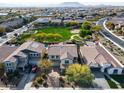 Gorgeous aerial view of a home with a beautiful community park and mountain views at 3933 E Alfalfa Dr, Gilbert, AZ 85298