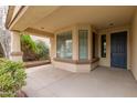 Covered front porch with a door and bay window, featuring a stone planter at 4041 E Lexington Ave, Gilbert, AZ 85234