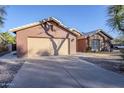 Two-car garage and front entry of a single story home at 4056 E Rosemonte Dr, Phoenix, AZ 85050