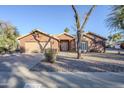 Single-story home with a two-car garage and well-maintained lawn at 4056 E Rosemonte Dr, Phoenix, AZ 85050