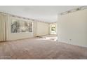 Spacious living room with large windows and carpet at 4079 E Yucca St, Phoenix, AZ 85028