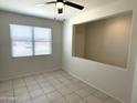 Spacious living room featuring tile floors and a ceiling fan at 42025 W Manderas Ln, Maricopa, AZ 85138