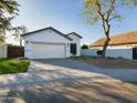 Front view of house with a two-car garage and artificial turf at 4229 E Crest Ct, Gilbert, AZ 85298