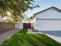 Side view of house showcasing a wooden gate and artificial turf at 4229 E Crest Ct, Gilbert, AZ 85298