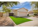 Well-maintained single-story home with a two-car garage and beautiful green synthetic grass at 4229 E Crest Ct, Gilbert, AZ 85298