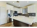 Modern kitchen with island, stainless steel appliances, and white cabinets at 4229 E Crest Ct, Gilbert, AZ 85298