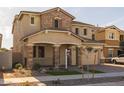 Two-story house with stone accents, landscaping, and a two-car garage at 4257 E John St, Gilbert, AZ 85295