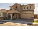 Two-story house with stone accents and a two-car garage at 4257 E John St, Gilbert, AZ 85295