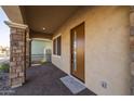 Covered front porch with stone columns and a modern front door at 4257 E John St, Gilbert, AZ 85295