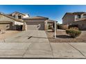 Two-story house with tan exterior, two-car garage, and small front yard at 42788 W Martie Lynn Rd, Maricopa, AZ 85138