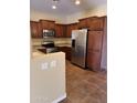 Modern kitchen with stainless steel appliances and tile flooring at 42788 W Martie Lynn Rd, Maricopa, AZ 85138