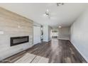 Open living area showcasing a modern electric fireplace and wood-look floors at 4346 E Earll Dr, Phoenix, AZ 85018