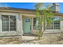 Front view of a charming house with a teal door and large windows at 4737 N 9Th St, Phoenix, AZ 85014