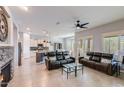 Open living room with fireplace and adjacent kitchen at 5927 E Sienna Bouquet Pl, Cave Creek, AZ 85331