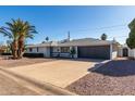 Newly renovated mid-century home with a large driveway and two-car garage at 7513 E Minnezona Ave, Scottsdale, AZ 85251