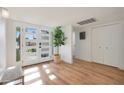 Bright entryway with white walls, wood floors, and a bench at 7730 E Buena Terra Way, Scottsdale, AZ 85250