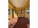 Inviting house entrance with terracotta tile flooring and a wood door at 8210 S 132Nd Ave, Goodyear, AZ 85338