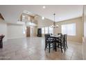 Spacious dining area with tile floors and a view into the living room at 9017 W Pinnacle Vista Dr, Peoria, AZ 85383