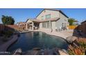 Large backyard pool with a waterfall feature at 9017 W Pinnacle Vista Dr, Peoria, AZ 85383