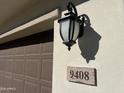 House number and light fixture on exterior wall at 9408 E Supernova Dr, Mesa, AZ 85212